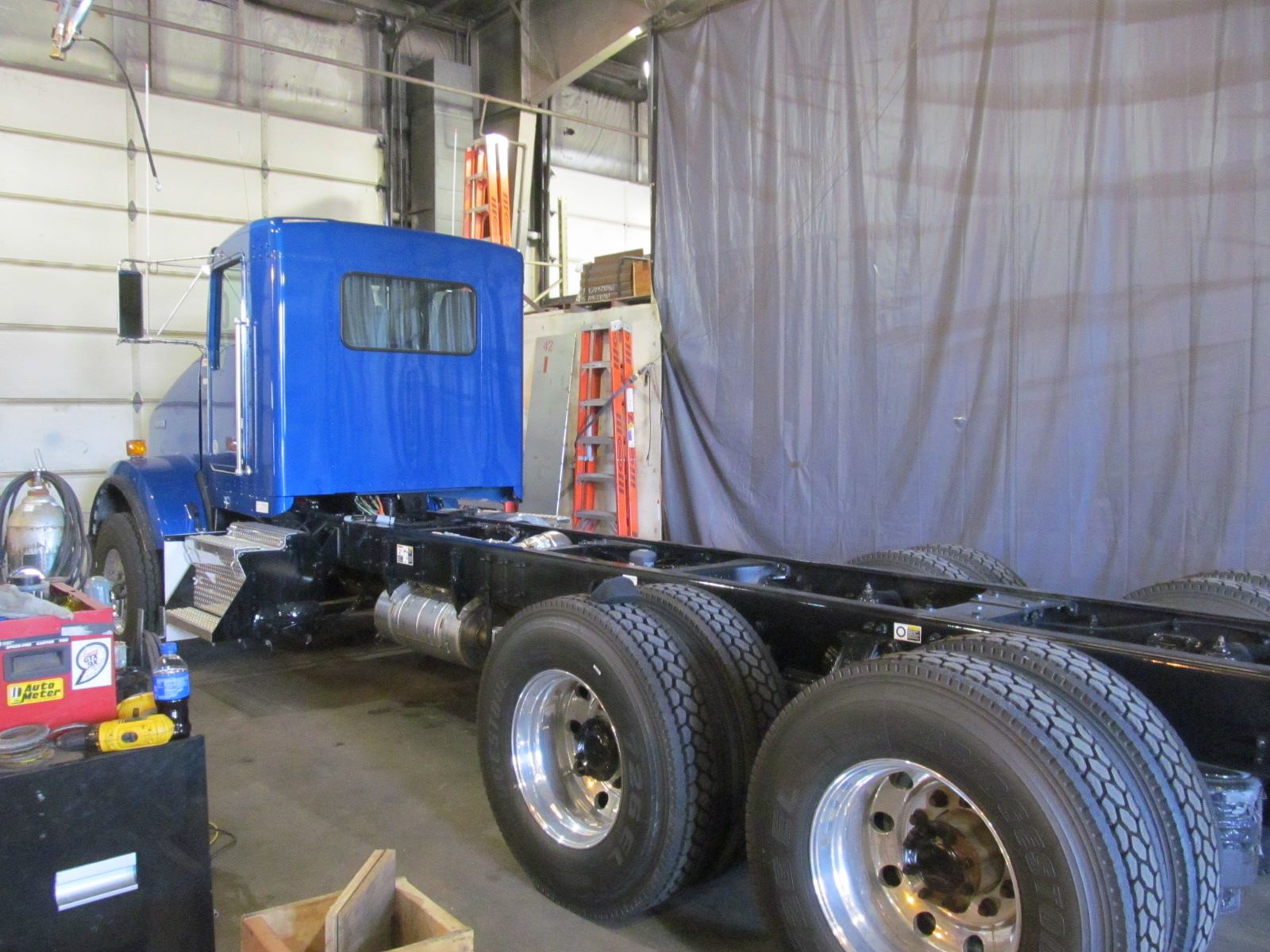 blue truck with a long trailer detatched