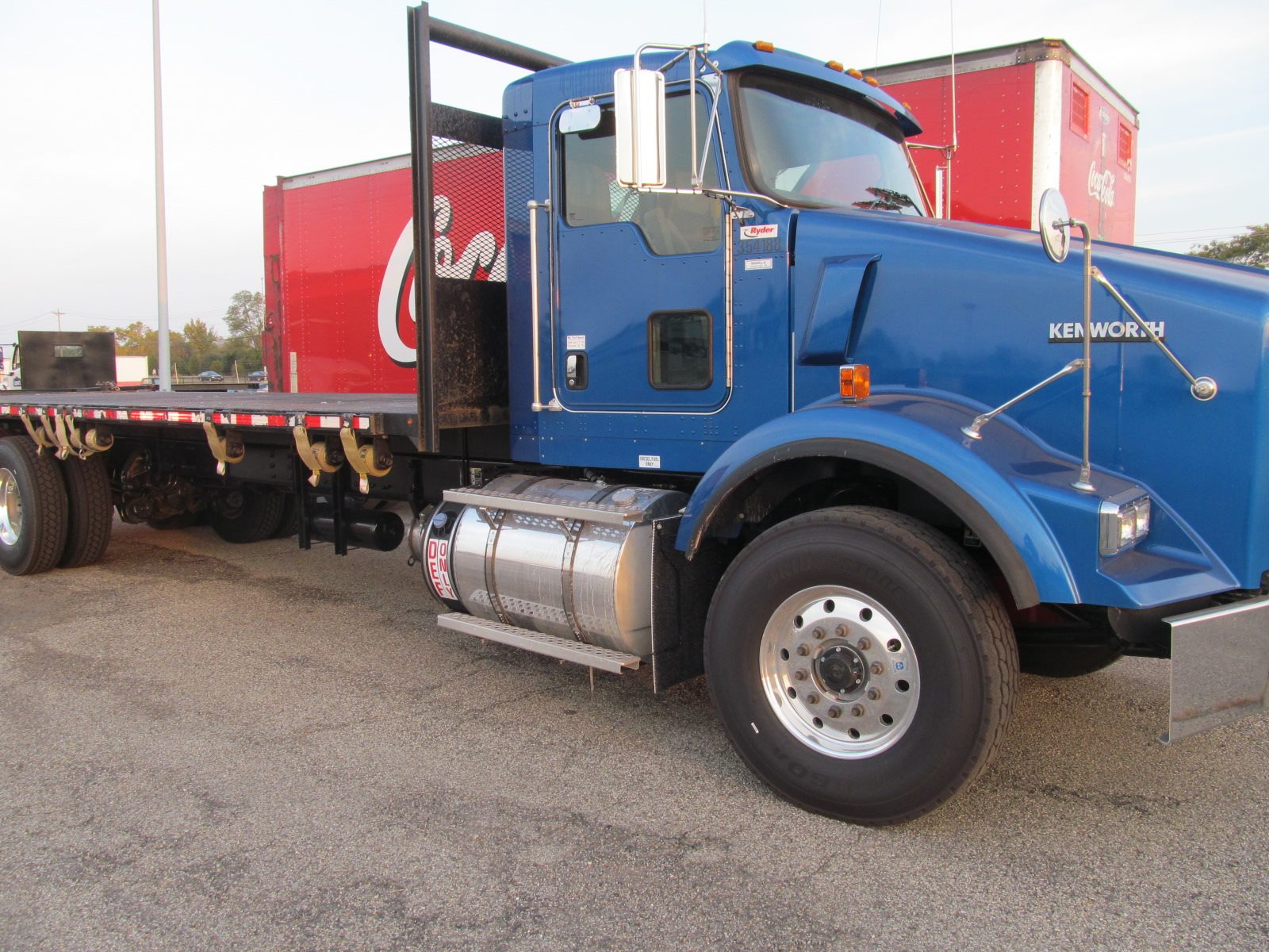 blue truck with a long trailer attached