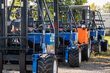 several fork lifts lined up in a row
