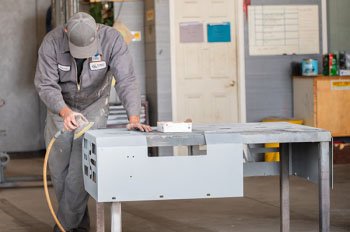 a man polishing a piece of metal